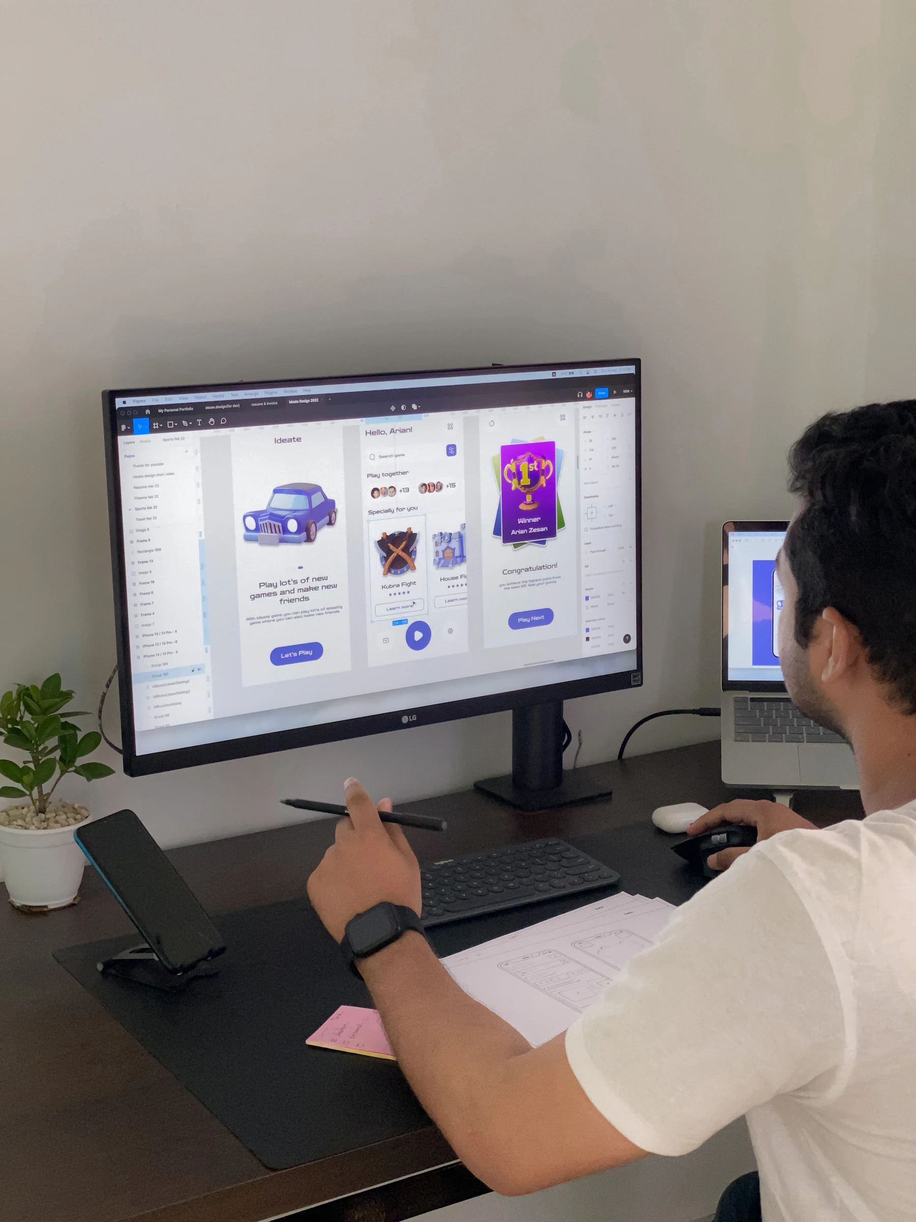 A designer reviewing app screens on a large monitor