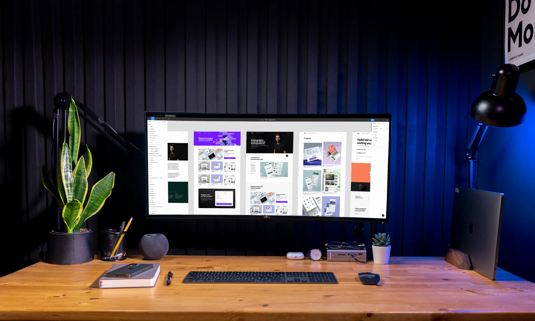 A desk with a monitor showing interface designs