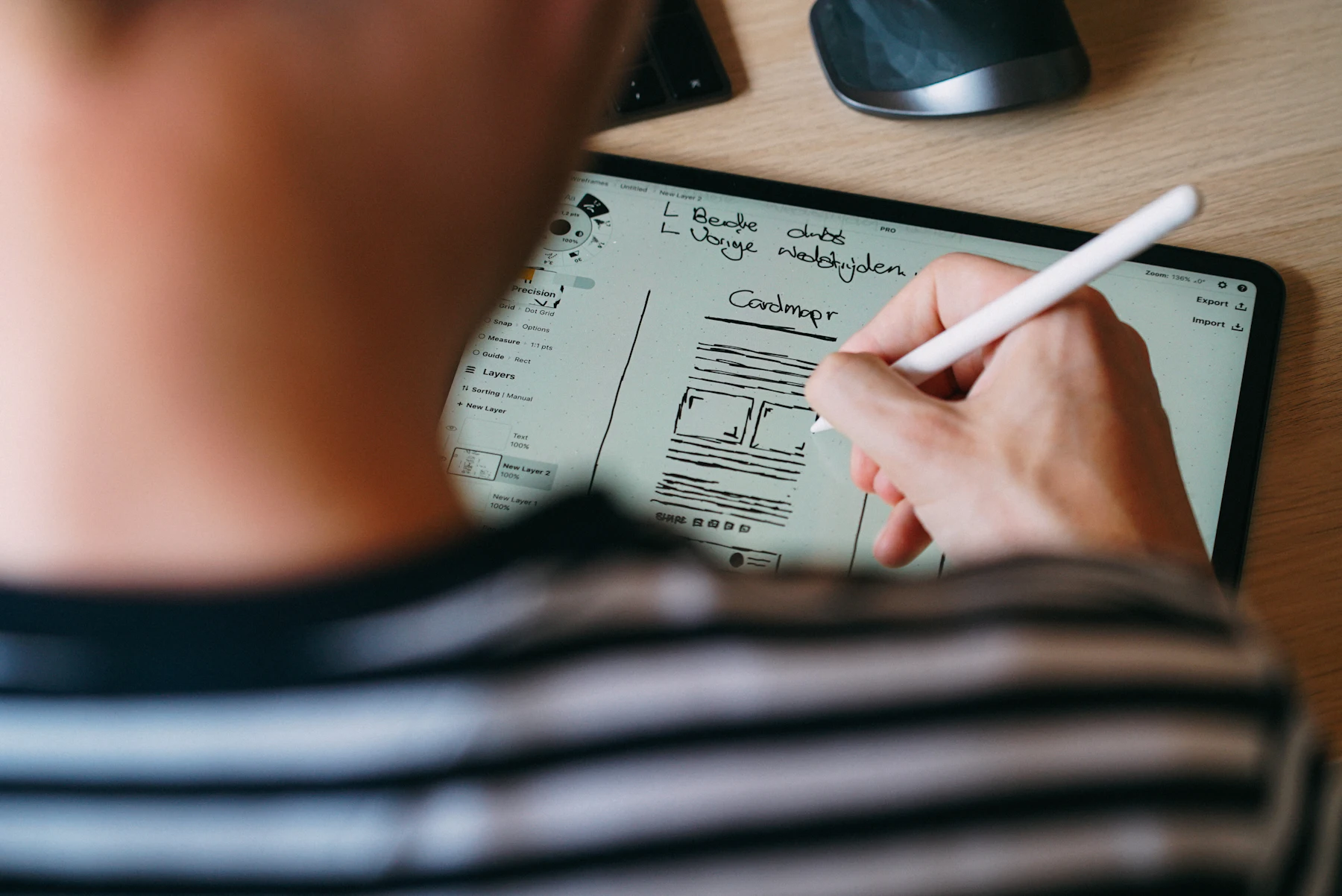A designer drawing a wireframe on a tablet
