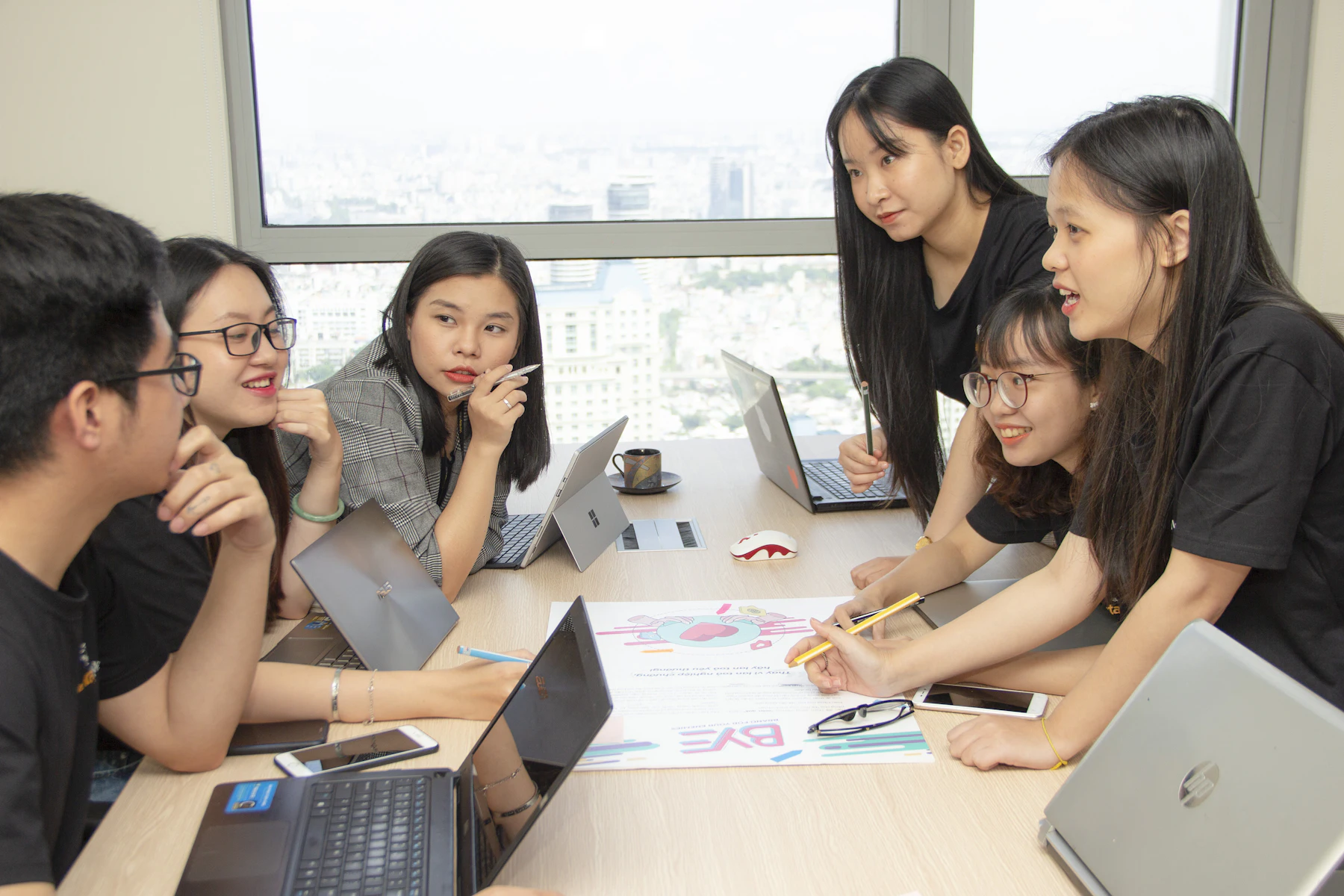 A small team discussing work around laptops