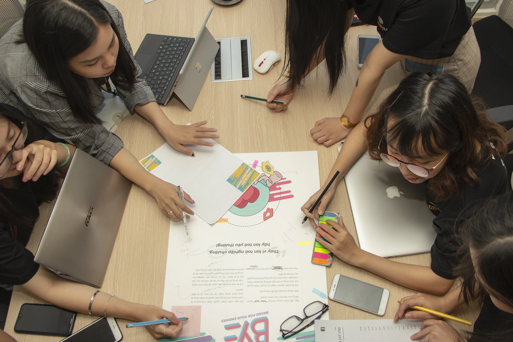 A team working around a table covered with sketches and notes